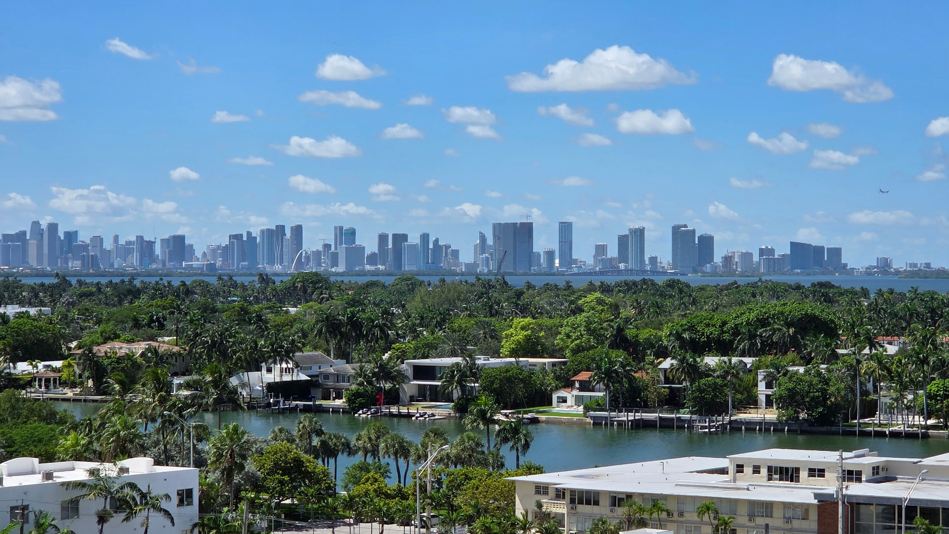 Waterfront homes along Biscayne Bay with the Miami skyline in the background