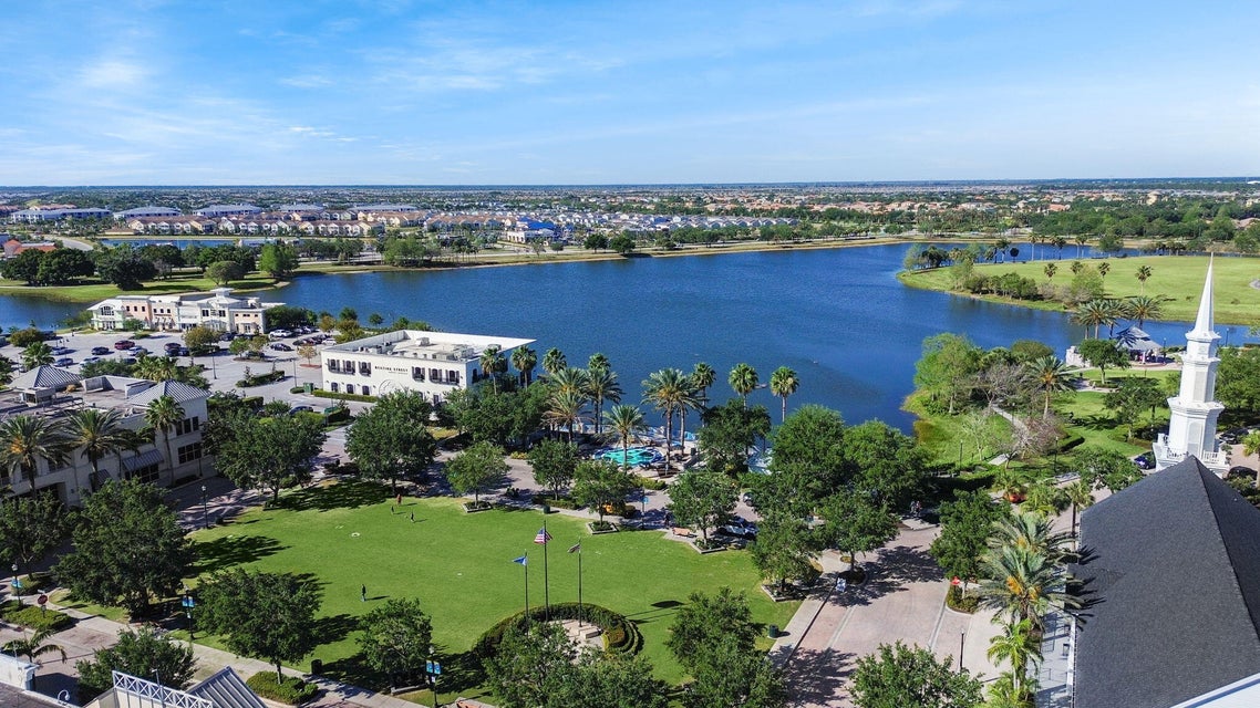 Wide daytime aerial view of a large lake, palm trees and landscaped residential development in Port St. Lucie, Florida