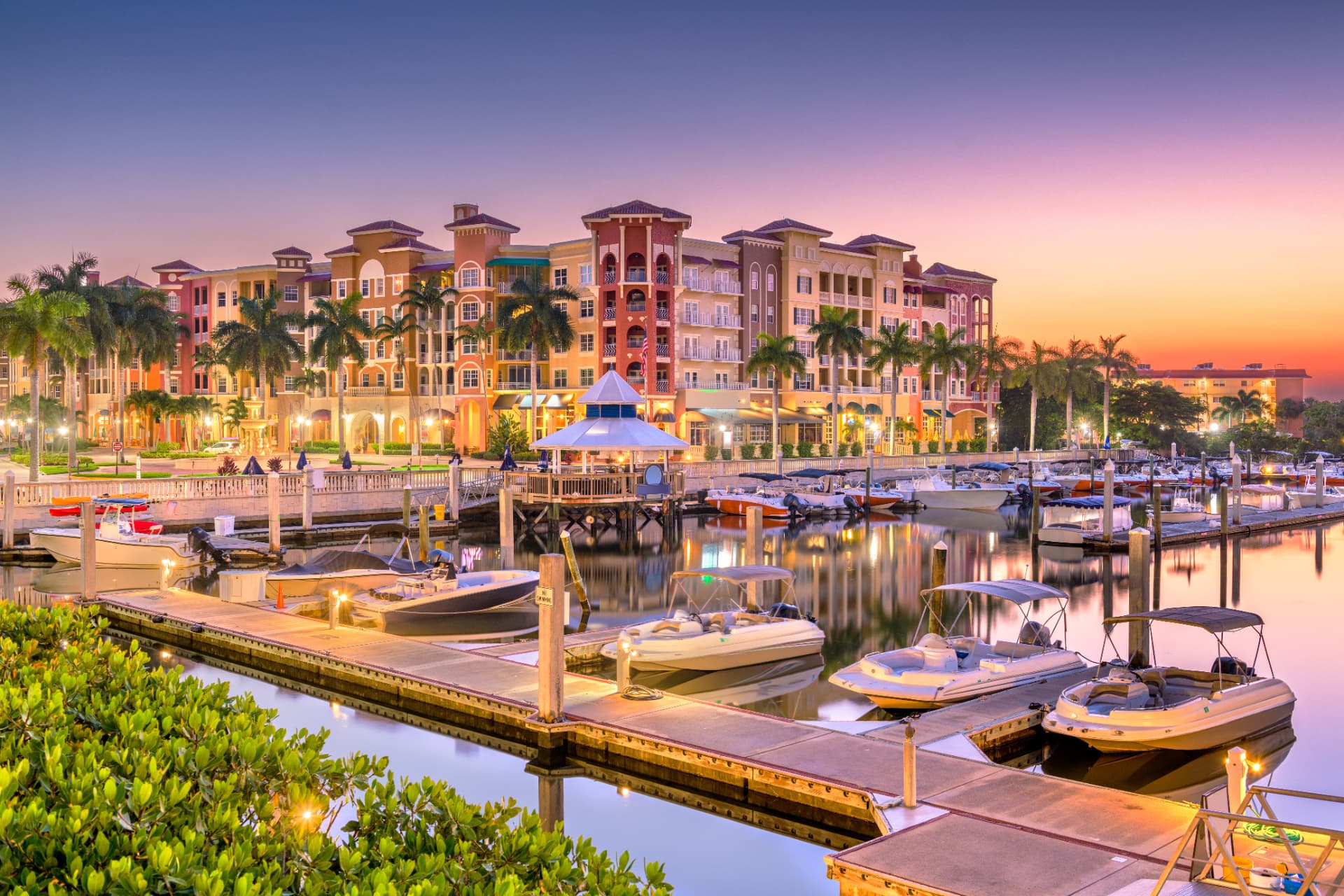 Waterfront residences and marina in Naples, Florida at sunset